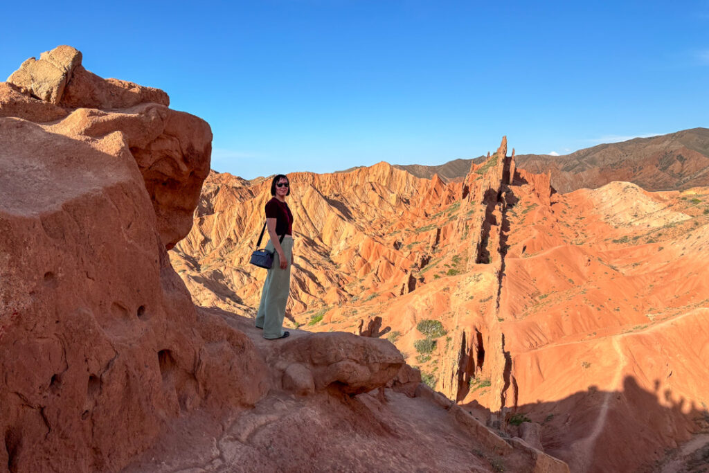 Eine Frau inmitten von roten Felsen und Weitblick